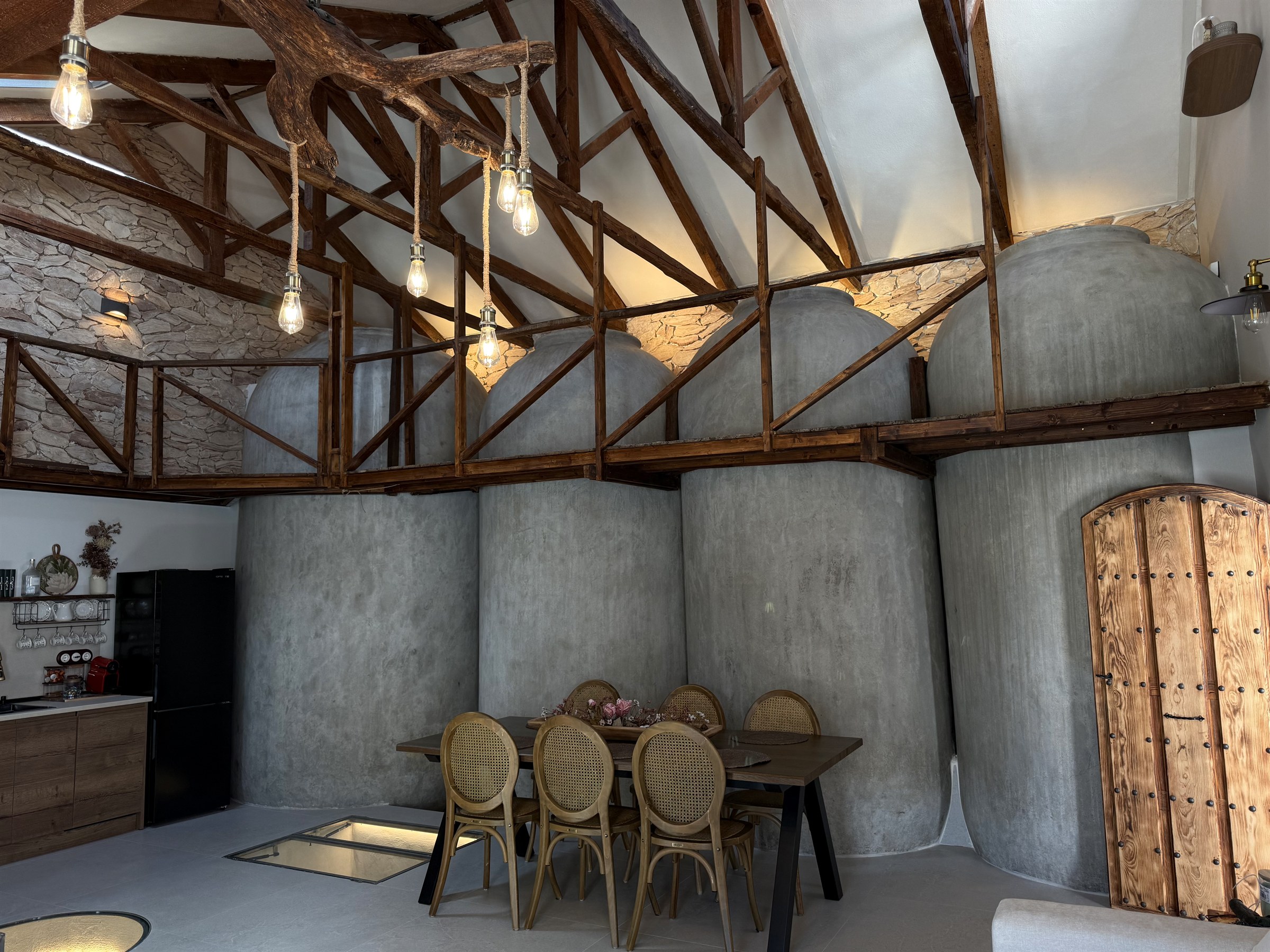 Interior de El Descanso de Alcolea, con vigas de madera, tinajas centenarias y comedor
